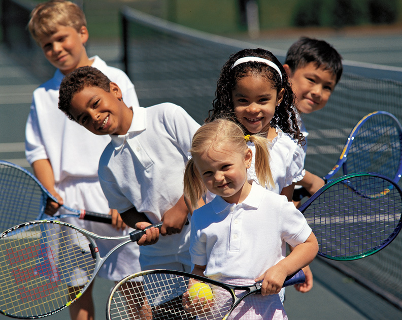 An image of children with tennis rackets. 